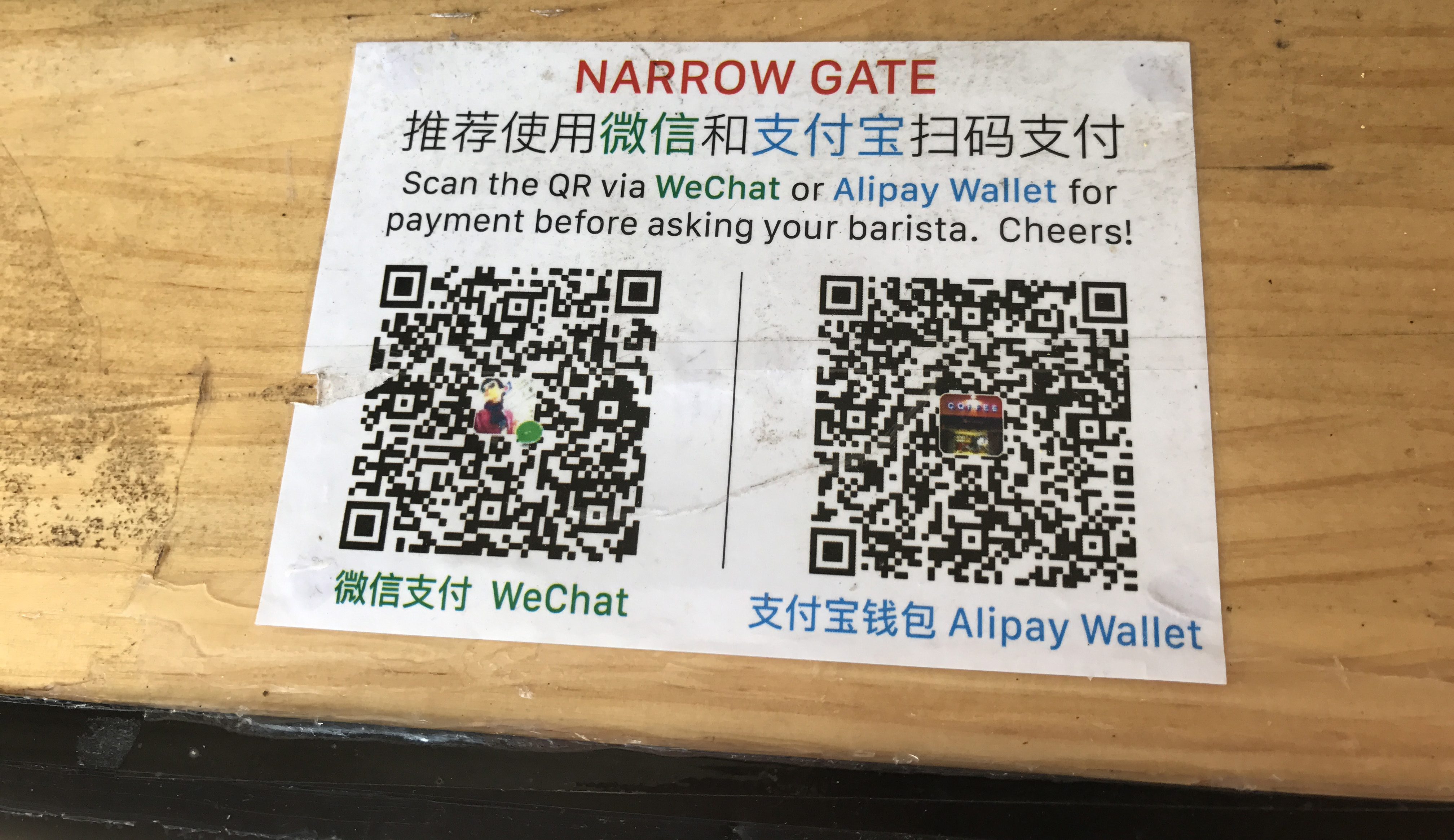WeChat Pay and Alipay QR codes displayed side by side at a merchant in China