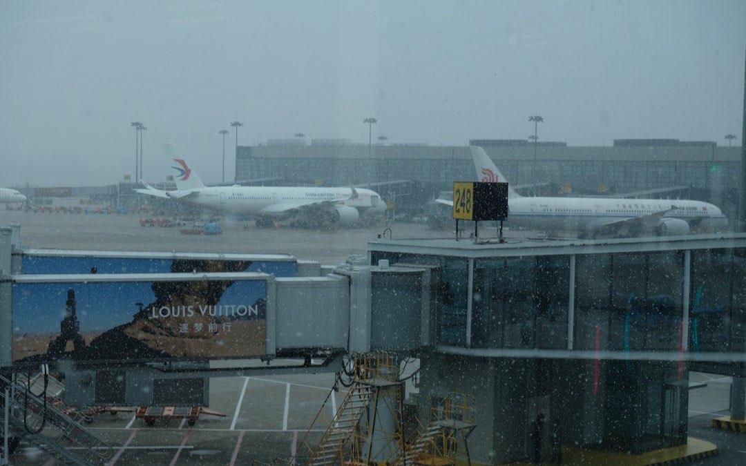 Airliner waiting at the gate, seen through an airport terminal window