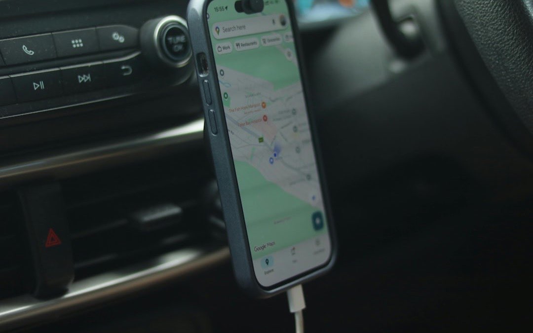 Smartphone mounted on a car dashboard showing a ride navigation route