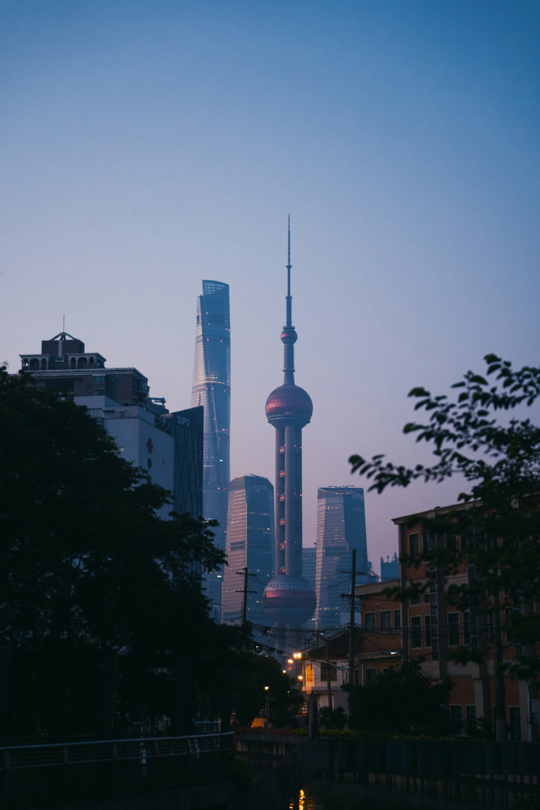 The Oriental Pearl Tower and Lujiazui skyline at dusk in Shanghai